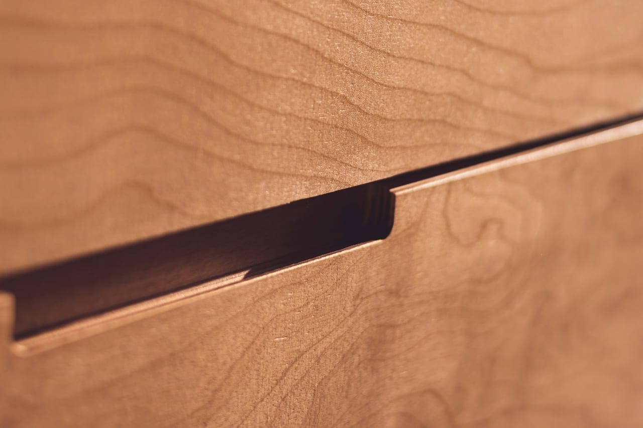 Joinery reference — timber grain and a restrained edge. Independent licensed reference.